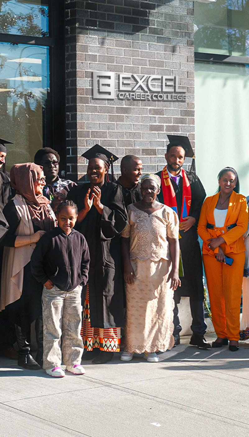 Group of graduates and family members celebrating outside a college building
